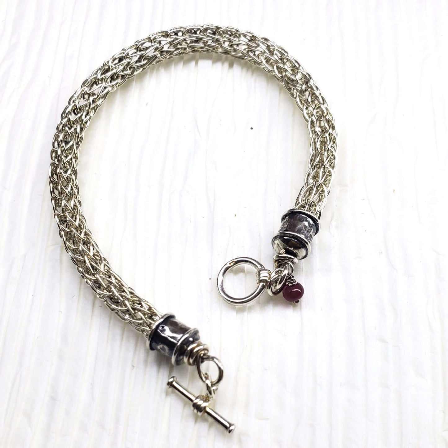 Handmade 10mm silver Viking knit bracelet with Ruby charm